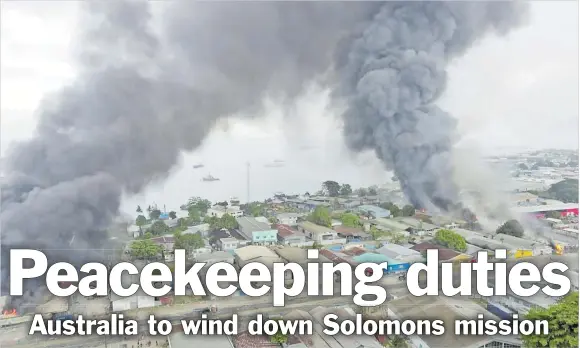  ?? Picture: REUTERS ?? Smoke rises above buildings after days of unrest in Honiara, Solomon Islands last month in this still image obtained from a video recorded on November 25, 2021 and obtained November 27, 2021.