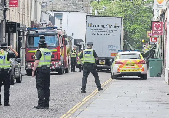  ?? Picture: George McLuskie. ?? Emergency services at the scene of the incident in Bell Street, St Andrews, yesterday.