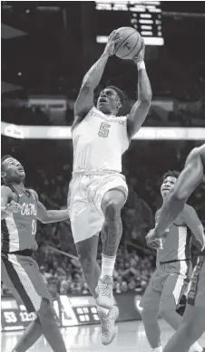  ?? THE ASSOCIATED PRESS ?? Tennessee’s Admiral Schofield goes up for a basket against Ole Miss on Saturday at Thompson-Boling Arena. The Vols beat the Rebels 94-61.