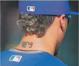  ?? PABLO MARTINEZ MONSIVAIS/AP ?? The Major League Baseball logo on the back of Javy Baez’s neck.