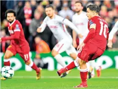  ??  ?? Liverpool’s Brazilian midfielder Philippe Coutinho scores from the penalty spot for the opening goal during the UEFA Champions League Group E football match between Liverpool and Spartak Moscow at Anfield in Liverpool, north-west England on December 6,...