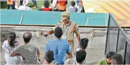  ??  ?? A policeman at the South Pavilion West seating orders spectators to clear the place as they watch the post-match ceremony at the RGICS in Hyderabad on Saturday.