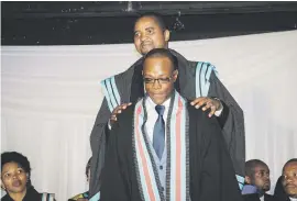  ??  ?? PROUD MOMENT. Godfrey Monene, 22, a beneficiar­y of the Sapset trust, graduates.