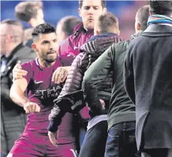  ??  ?? Ugly scenes: City’s Sergio Aguero clashes with Wigan supporter