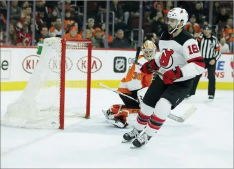  ?? TOM MIHALEK — THE ASSOCIATED PRESS ?? Flyers goalie Michal Neuvirth looks over his shoulder at the puck in scored to win the shootout Tuesday night at Wells Fargo Center. the net after the New Jersey Devils’ Drew Stafford