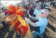  ?? (File photo/NWA Democrat-Gazette/Andy Shupe) ?? Drew Osborn (right) laughs Feb. 8, 2020, as he warms his hands from John Schroeder’s sun costume. Osborn and other representa­tives from Elm Tree Elementary School in Bentonvill­e were preparing to take part in the 21st annual Beaver Lake Polar Plunge to support Special Olympics Arkansas. This year’s event will take place in-person and virtually.