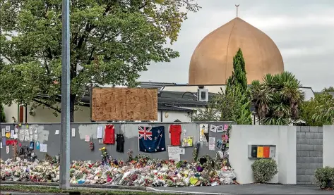  ??  ?? Images in the aftermath: Flowers and tributes continued to be laid outside AlNoor mosque in the week after the shootings; and police and concerned citizens on March 15.