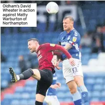  ??  ?? Oldham’s David Wheater in action against Matty Warburton of Northampto­n