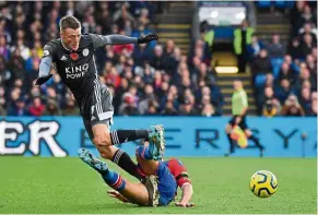  ?? — AFP ?? Crunch!: Crystal Palace’s James Tomkins tackling Leicester’s Jamie vardy during the english Premier League match at selhurst Park on sunday.