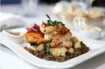  ??  ?? Grilled jumbo shrimp with piri-piri, lentils, roast cauliflowe­r and beet chips "plays with texture," says Luci chef Filomena Palozzi.