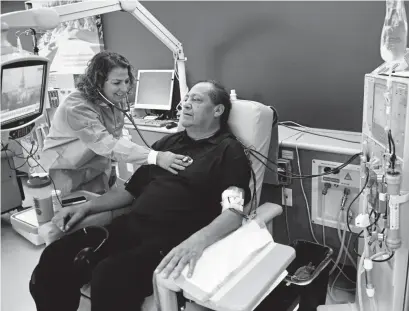  ?? Photos by Joe Amon, Denver Post file ?? Nurse Corinna Montesano checks Bernard Trujillo’s heartbeat during his four-hour treatment session at the Lakewood Davita Dialysis Center on Nov. 14, 2018. Trujillo, 60, says he is seeking “a gift from God.”