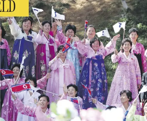  ?? PYONGYANG PRESS CORPS POOL VIA AP ?? Women wearing traditiona­l outfits line the streets of Pyongyang to welcome South Korean President Moon Jae-in on Tuesday. The visit marks the first trip of a South Korean leader to the North Korean capital in 11 years.
