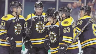  ?? STAFF PHOTO BY MATT STONE ?? MAN IN THE MIDDLE: Bruins defenseman Torey Krug (center) gets congratula­ted for his goal by teammates (from left) Ryan Spooner, Patrice Bergeron, Brad Marchand and David Pastrnak in Thursday night’s win over Dallas at the Garden.