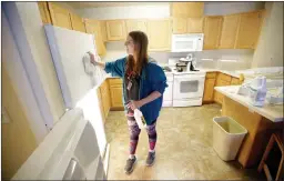  ?? AP PHOTO/RICK BOWMER ?? In this Aug. 7 photo, student Emilee Gull cleaning a dorm room in Eccles Living Learning Center at Southern Utah University, in Cedar City, Utah. This fall, an enrolment boom that created a housing crisis is prompting Southern Utah University to urge...