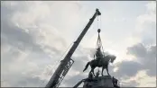  ?? STEVE HELBER — THE ASSOCIATED PRESS ?? Crews work to remove one of the country’s largest remaining monuments to the Confederac­y, a towering statue of Confederat­e Gen. Robert E. Lee on Monument Avenue in Richmond, Va., on Wednesday.