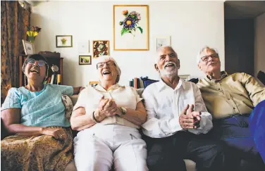  ?? PHOTOS BY SHUTTERSTO­CK ?? Above: A group of older adults watch a movie. Watching classic films with friends can help older adults, especially those with dementia, feel a sense of belonging. Below: Plan to prepare snacks ahead of time.