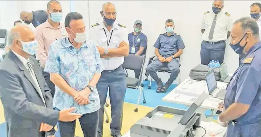  ?? Picture: SUPPLIED ?? Fiji Revenue and Customs Service (FRCS) board chair Mahmood Khan and Fiji Airways managing director and CEO Andre Viljoen being briefed on the trace detection device given by the New Zealand Government.