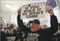  ?? Associated Press ?? Oakland Raiders fans hold up signs and yell during a rally to keep the team from moving Saturday in Oakland. NFL owners are expected to vote on the team's possible relocation to Las Vegas on Monday.