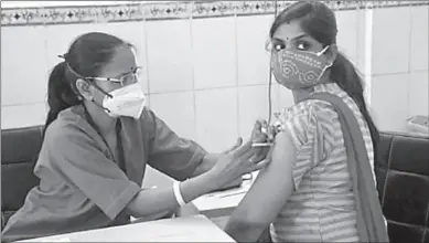  ??  ?? JAIPUR
A young beneficiar­y receives the first dose of Covid-19 vaccine at JK Lon Hospital in Jaipur, Rajasthan.
-AP