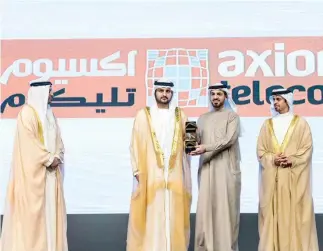  ??  ?? Fahad Al-Bannai, CEO of Axiom Telecom, third from left, receives the award.