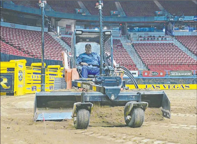  ?? PRCA ?? It’s not an uncommon sight to see Allen Rheinheime­r driving a tractor, making sure the surface is just right each night for the riders, ropers, racers and wrestlers.