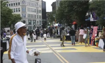  ?? Boston HerAld file ?? OUT AND ABOUT: People enjoy last summer’s ‘Buy the Block Party’ in Nubian Square, where developmen­t is under way for Parcel 3.