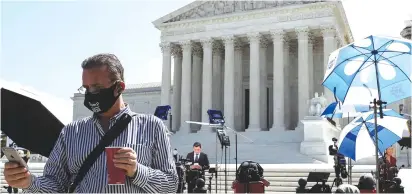  ?? (Leah Millis/Reuters) ?? MEMBERS OF the media gather outside the US Supreme Court yesterday.