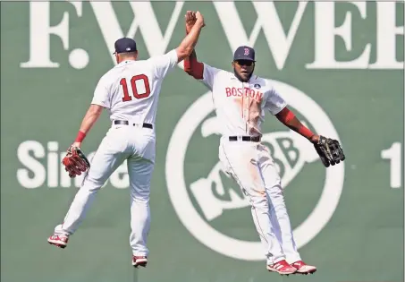  ?? Elise Amendola / Associated Press ?? Red Sox outfielder­s Hunter Renfroe (10) and Franchy Cordero celebrate their 11-4 victory over the White Sox on Monday.