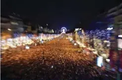  ??  ?? New Year revelers gather on the Champs-Elysees avenue in Paris.