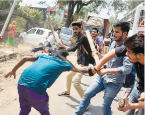  ??  ?? A PROTESTER being beaten after members of the Dalit community and other “low caste” groups reportedly resorted to violence during countrywid­e protests, in Meerut, Uttar Pradesh, on April 2.