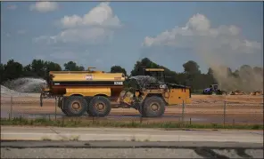  ?? Arkansas Democrat-Gazette/DALE ELLIS ?? A tanker sprays water last week on the constructi­on site of the Saracen Casino Resort in Pine Bluff. The water is intended to keep the dust down.