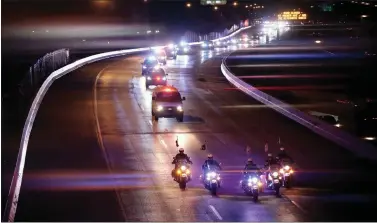  ?? ASSOCIATED PRESS ?? Police form a procession on Interstate 95in Philadelph­ia early Monday, March 21, for two Pennsylvan­ia State troopers who were killed in a multi-vehicle collision that occurred on I-95 southbound in South Philadelph­ia.