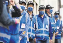  ??  ?? Oakland Chinatown Blue Angels Volunteer Patrol Team members during a joint news conference on addressing crime.