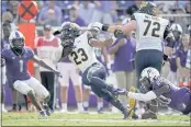  ?? TONY GUTIERREZ — THE ASSOCIATED PRESS ?? Cal running back Marcel Dancy (23) is caught from behind by TCU safety La’Kendrick Van Zandt (20) as Tre’Vius Hodges-Tomlinson (1) and Cal’s McKade Mettauer (72) look on in the second half Saturday in Fort Worth, Texas.