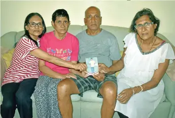  ?? Photo: Karalaini Tavi ?? From left: Agnes Rodgers, Elizabeth Nirmala, John Shankaran and Puspha Shankaran with their brother's picture at their home in Matintar Nadi on October 7, 2017.