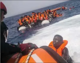  ?? SANTI PALACIOS — THE ASSOCIATED PRESS ?? Sea rescue: An African migrant tries to reach a rescue boat from the Spanish NGO Proactiva Open Arms, after being located sailing out of control on a punctured rubber boat in the Mediterran­ean Sea, about 12 miles north of Sabratha, Libya, on Sunday.