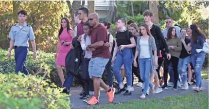  ??  ?? Right after the shooting at Marjory Stoneman Douglas High School in Parkland, Fla., the focus was on grieving. But with students returning to class, the mind-set of many has shifted to protection. MICHELE EVE SANDBERG/AFP/GETTY IMAGES