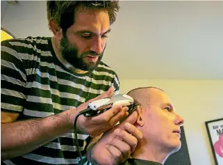  ?? PHOTOS: DAVID WALKER/STUFF ?? Chalky Carr and his sons, Josh and Jamie, had their heads shaved by Crusaders captain and All Black Sam Whitelock, the aim is to raise $100,000 for Isla’s future.