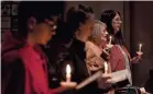  ?? JACK GRUBER/USA TODAY ?? A candleligh­t vigil was held Wednesday at St. Thomas Episcopal Church in Chesapeake, Va., to honor the victims of Tuesday’s mass shooting.