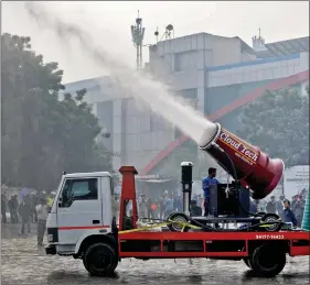  ?? REUTERS ?? A man operates an ‘anti-smog gun’, a machine that sprays atomised water into the air to reduce pollution, during its trial run organised by the Department of Environmen­t and Delhi Pollution Control Committee at a bus terminal in New Delhi, on Wednesday.