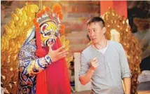  ?? PROVIDED TO CHINA DAILY ?? Director Cheng Lu instructs a performer during production of the Peking Opera film HavocinHea­ven.