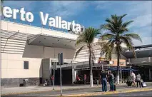  ?? CESAR RODRIGUEZ / BLOOMBERG ?? Travelers outside Licenciado Gustavo Diaz Ordaz Internatio­nal Airport in Puerto Vallarta, Mexico, on March 6.