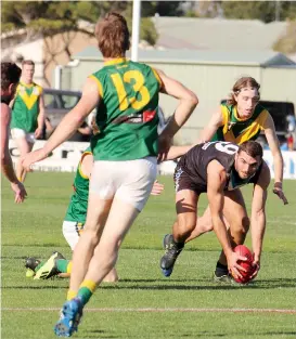  ??  ?? Leongatha’s Chris Verboon (left) and Jack Hume (right) bore down on Wonthaggi’s Timothy Knowles in the nail-biting match on Good Friday.