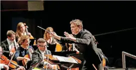  ?? [PHOTO BY SHEVAUN WILLIAMS] ?? Music Director Alexander Mickelthwa­te leads the Oklahoma City Philharmon­ic at a previous concert.