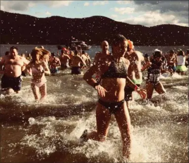  ?? BY PAUL POST ?? More than 800people braved Lake George’s icy water for a New Year’s Day Polar Bear Plunge on Tuesday.