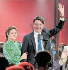  ?? /Reuters ?? Vote
counting: Canada’s Liberal Prime Minister Justin Trudeau, seen here with his wife Sophie Gregoire, looks set to remain in power, albeit with a minority of House of Commons seats.