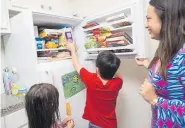  ?? Brandon Thibodeaux, © The New York Times Co. ?? Isobella Jade buys frozen meals in bulk to keep her two children, Phoenix, center, and Vivian, fed in Houston.