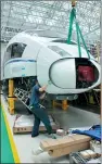  ??  ?? An employee works on an assembly line for high-speed railways at CRRC Changchun Railway Vehicles Co Ltd.