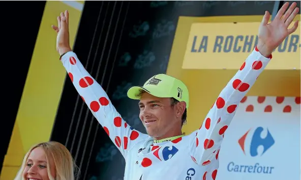  ?? AP, GETTY IMAGES ?? New Zealand’s Dion Smith wears the polka dot jersey on the podium after stage two of Tour de France yesterday. At left, Smith in the early breakaway along with Michael Gogl and Sylvain Chavanel.