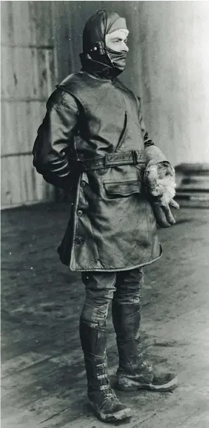  ??  ?? WW I–era flight garb was a mixture of whatever pilots could find—typically, from commercial sources—to protect themselves from wind blast and temperatur­e extremes. This aviator wears a flying coat from Harrods, of England; a Russian helmet; and gloves from Greenbaum, Weit, and Michaels. Note that the buttons are at the side to block the path of a frontal wind blast. The slash opening on the chest is for maps and dispatches. (Photo courtesy of the Naval Aviation Historical Center via the author)